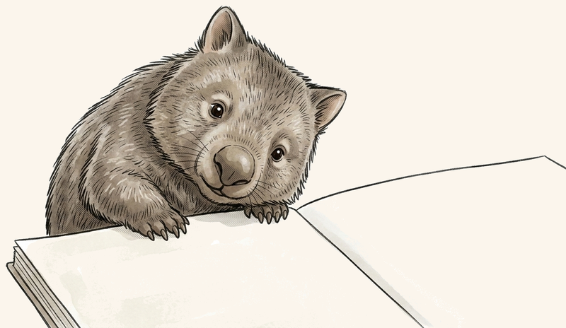 Digby the wombat resting his paws on a page